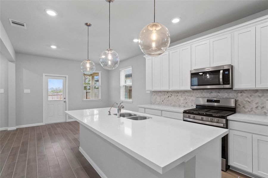 The kitchen island provides a convenient breakfast bar, perfect for casual dining and or long conversations.