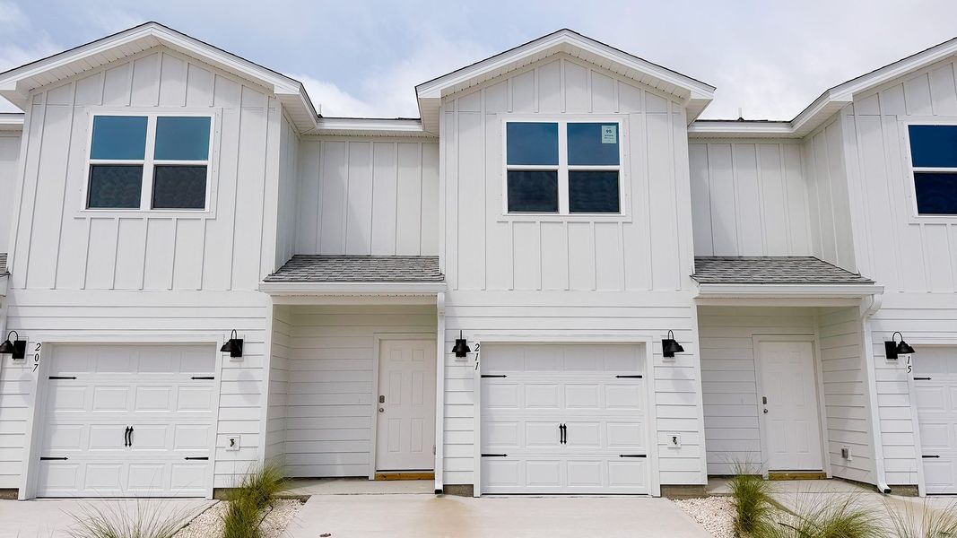 Front exterior of a new home in Salt Creek Townhomes at Mexico Beach, Mexico Beach, FL, highlighting curb appeal (Image 1). Front exterior of a new home in Salt Creek Townhomes at Mexico Beach, Mexico Beach, FL, highlighting curb appeal (Image 1).