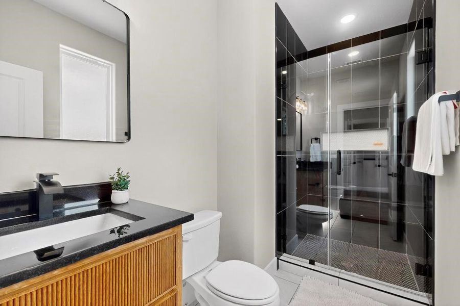 Bathroom featuring vanity, a stall shower, and recessed lighting