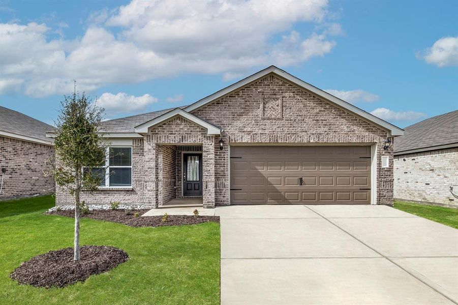 View of front of property featuring a garage and a front lawn