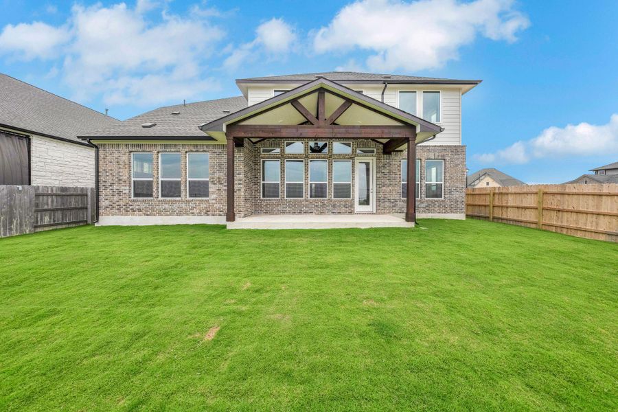 Rear view of property with a patio, brick siding, and a fenced backyard Rear view of property with a patio, brick siding, and a fenced backyard