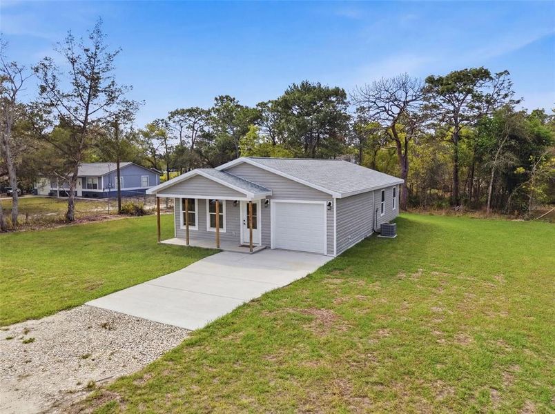 Front exterior of a new home in , Weeki Wachee, FL, highlighting curb appeal (Image 27).