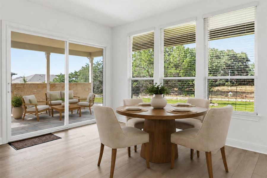 Virtually Staged. Natural light floods the dining area, revealing a spacious covered patio beyond the sliding glass doors. Virtually Staged. Natural light floods the dining area, revealing a spacious covered patio beyond the sliding glass doors.