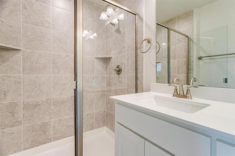 Bathroom featuring vanity and walk in shower