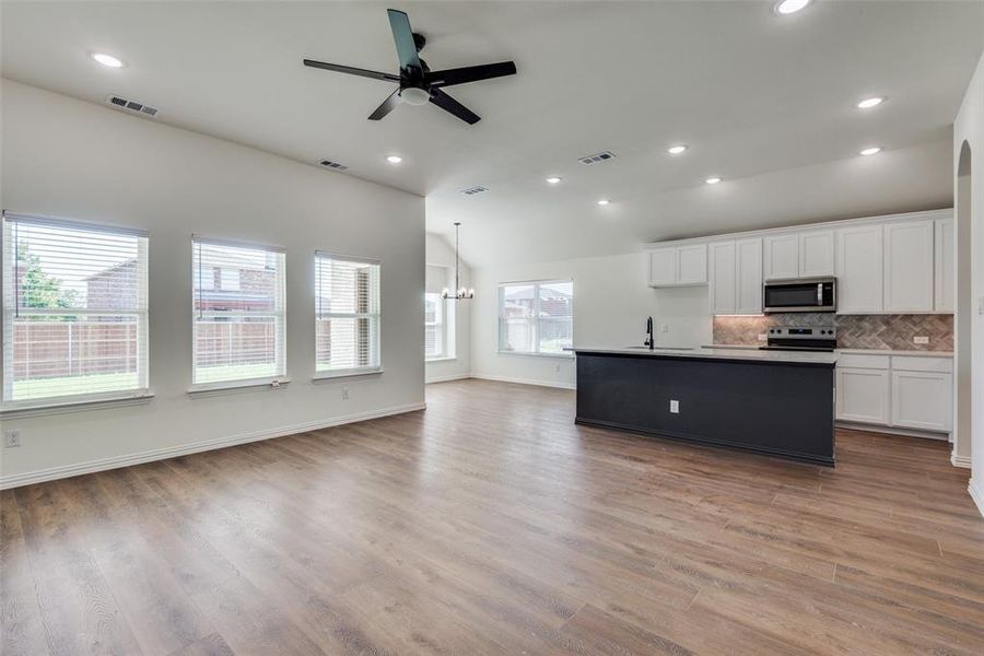 Kitchen featuring white cabinetry, sink, light wood-type flooring, and appliances with stainless steel finishes