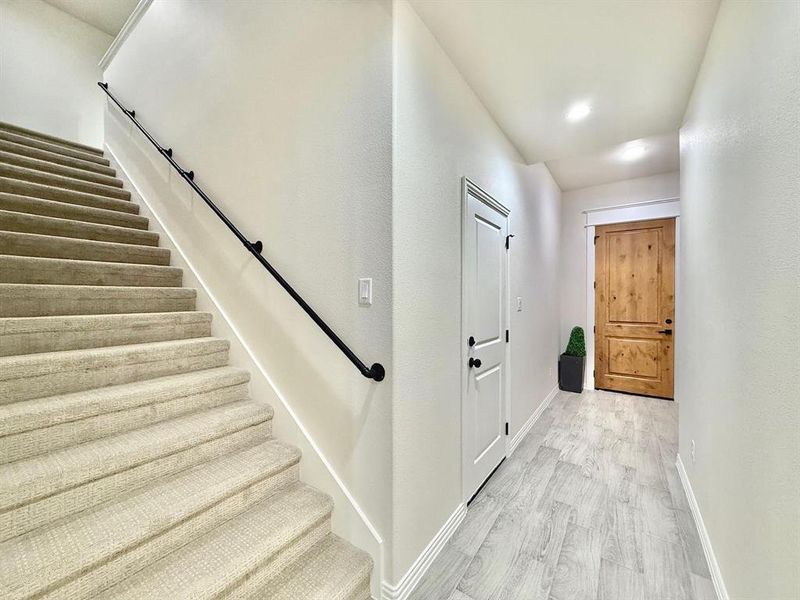 Staircase featuring wood finished floors and baseboards Staircase featuring wood finished floors and baseboards