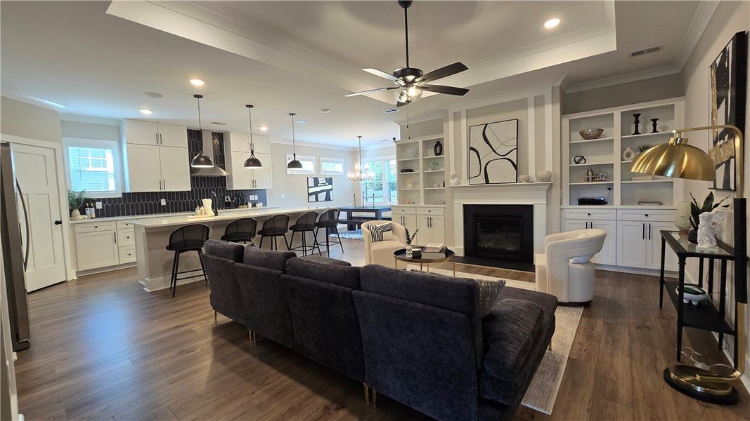An open-concept living area features rich wood flo An open-concept living area features rich wood flo