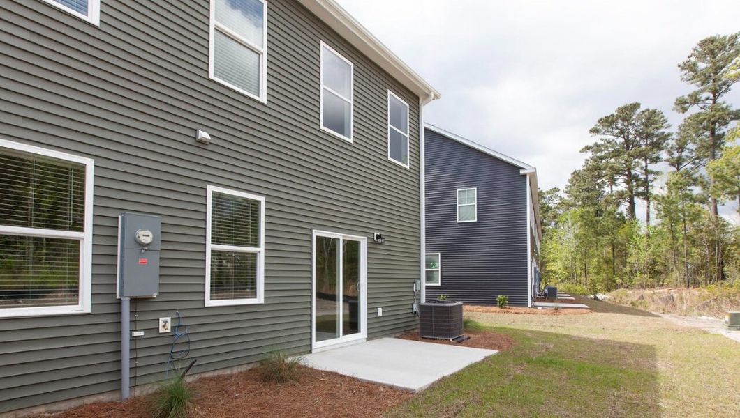 Exterior details and patio area of a home in Indigo Preserve Townhomes, Leland (Image 2). Exterior details and patio area of a home in Indigo Preserve Townhomes, Leland (Image 2).