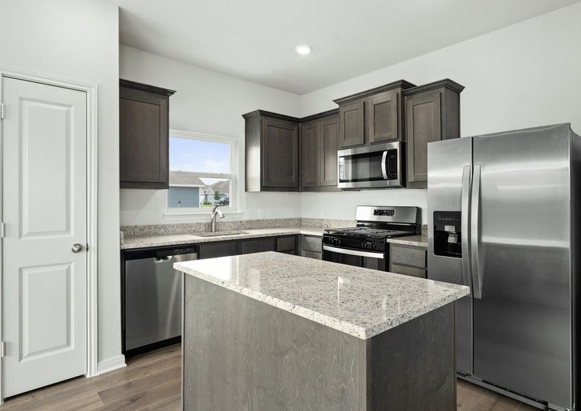 The kitchen has sprawling granite countertops.