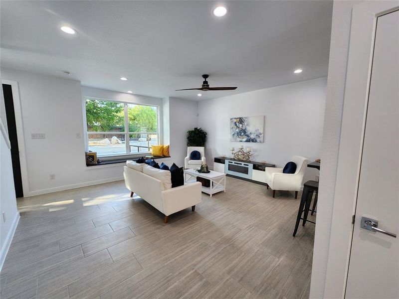 Living room with light wood-type flooring and ceiling fan