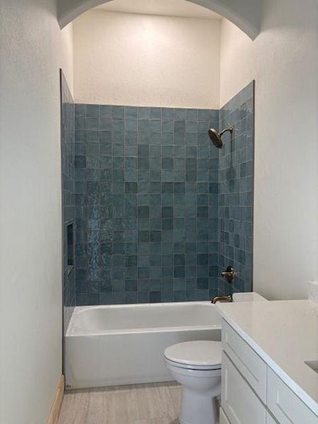 Full bath with shower / bath combination, vanity, and light wood-style floors