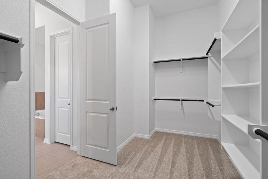 Walk-in closet in Primary Bedroom Walk-in closet in Primary Bedroom