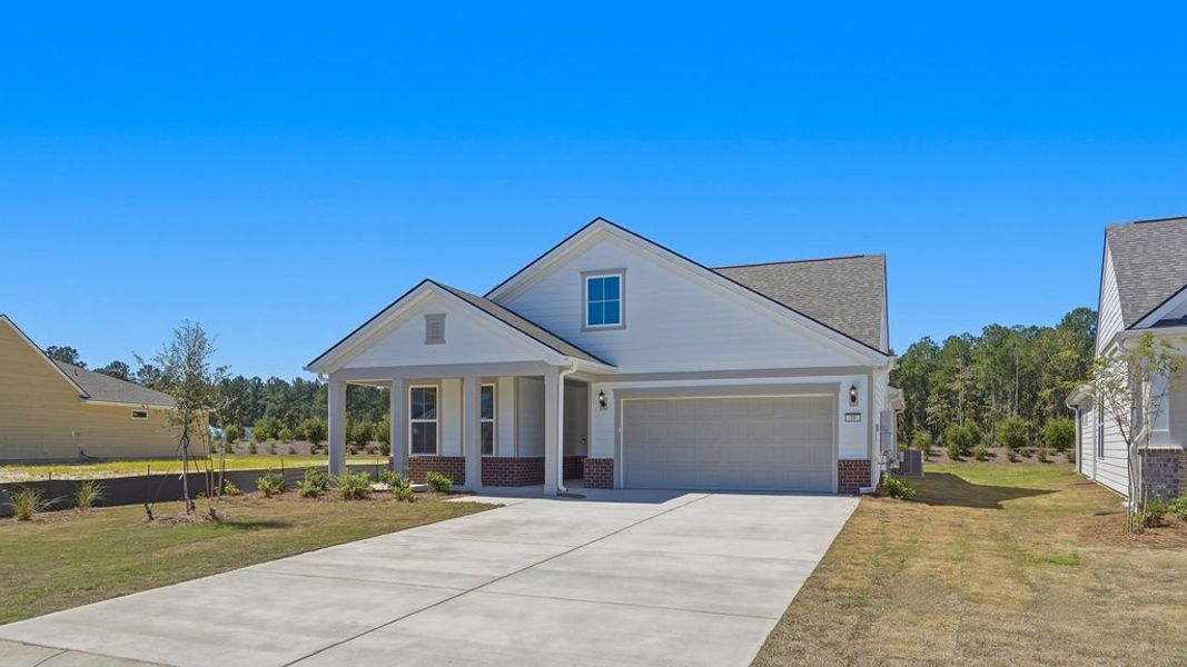 Front exterior of a new home in Sun City Hilton Head, Bluffton, SC, highlighting curb appeal (Image 2). Front exterior of a new home in Sun City Hilton Head, Bluffton, SC, highlighting curb appeal (Image 2).