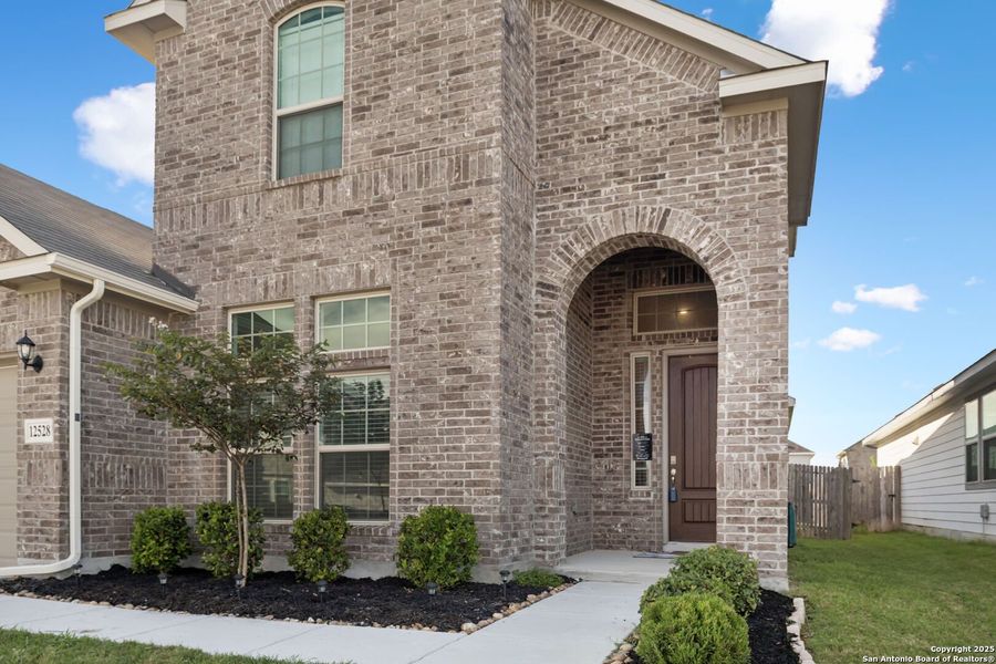 Front exterior of a new home in Rhine Valley, Schertz, TX, highlighting curb appeal (Image 1).