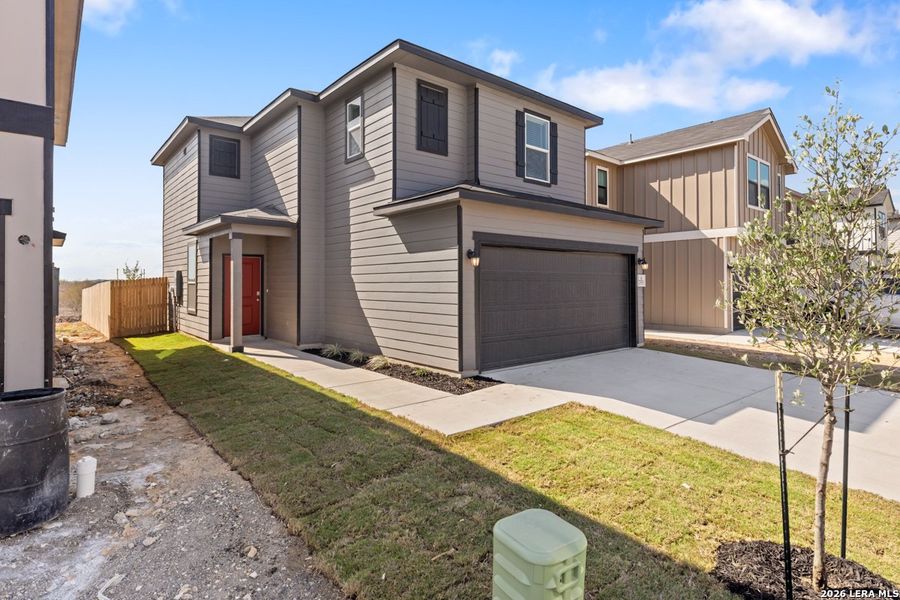 Front exterior of a new home in Preserve at Culebra - Villa Collection, San Antonio, TX, highlighting curb appeal (Image 1). Front exterior of a new home in Preserve at Culebra - Villa Collection, San Antonio, TX, highlighting curb appeal (Image 1).