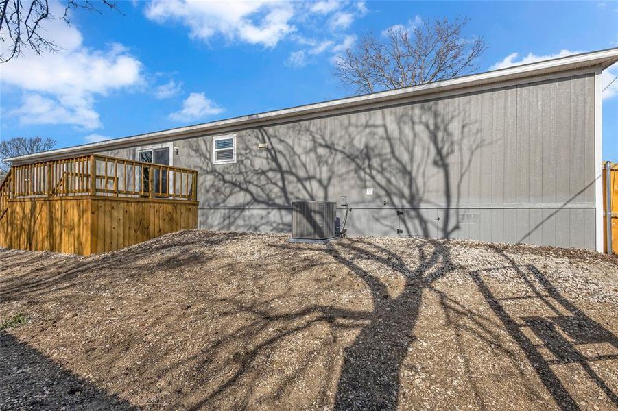 Rear view of property with a deck and cooling unit