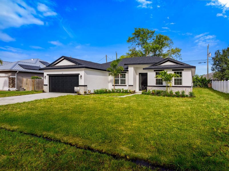 Front exterior of a new home in , Port St. Lucie, FL, highlighting curb appeal (Image 21). Front exterior of a new home in , Port St. Lucie, FL, highlighting curb appeal (Image 21).