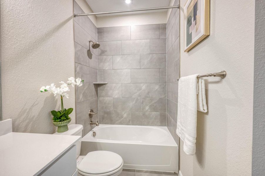 Modern stone tile surrounds the soaking tub in this sleek, clean bathroom. Modern stone tile surrounds the soaking tub in this sleek, clean bathroom.