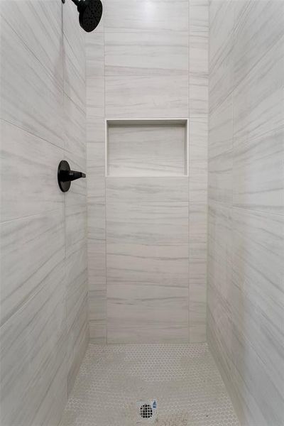 Bathroom featuring a tile shower