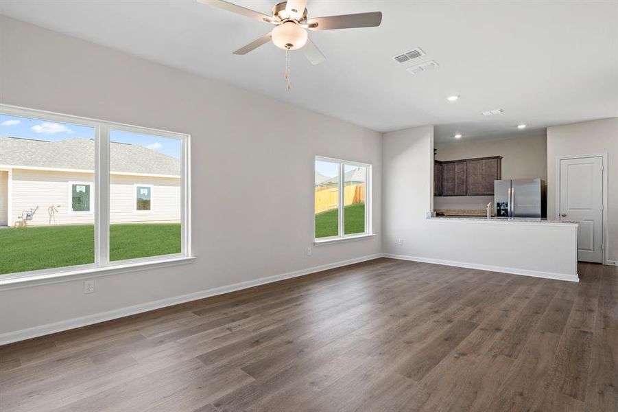 Unfurnished living room with dark wood-type flooring, recessed lighting, and a ceiling fan