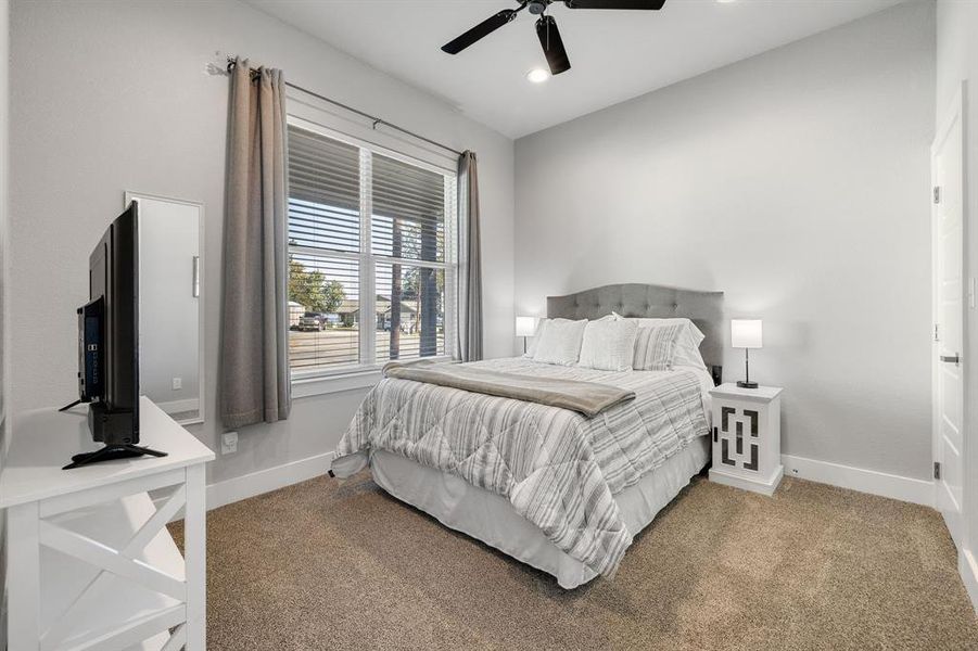 Bedroom with light colored carpet, recessed lighting, and ceiling fan