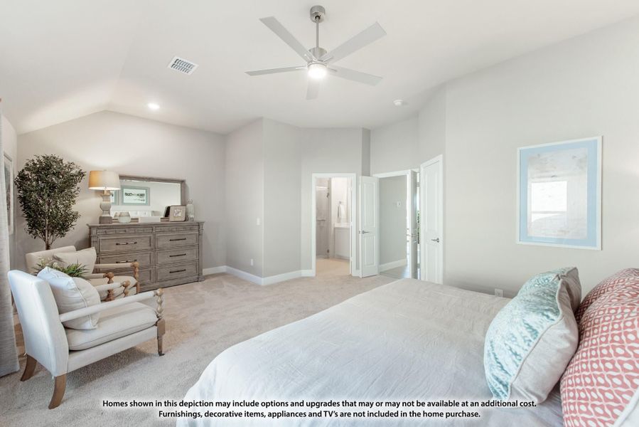 Spacious master bedroom with vaulted ceiling, ceiling fan, carpet flooring, and doors leading to ensuite bathroom and closet.