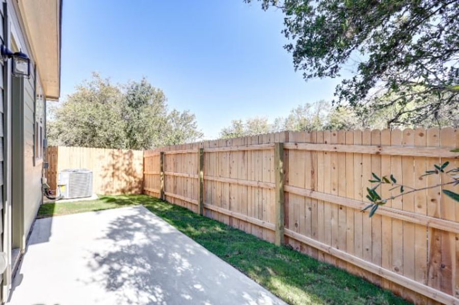 A wooden fence next to a building. A wooden fence next to a building.
