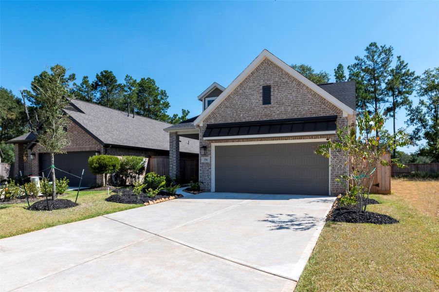 Front exterior of a new home in The Woodlands Hills, Willis, TX, highlighting curb appeal (Image 1).