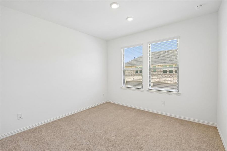 You'll find a nicely sized secondary bedroom in our Hansen floor plan.