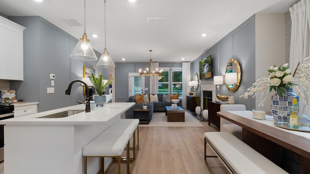 Spacious living area with abundant natural light, neutral walls, and recessed lighting.