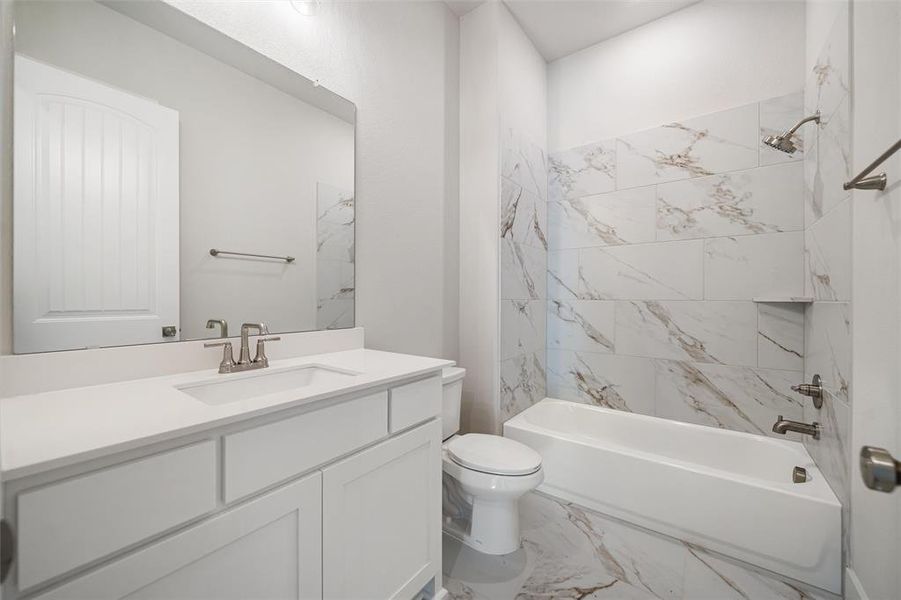 Full bath with marble look tiles, tub / shower combination, and vanity Full bath with marble look tiles, tub / shower combination, and vanity