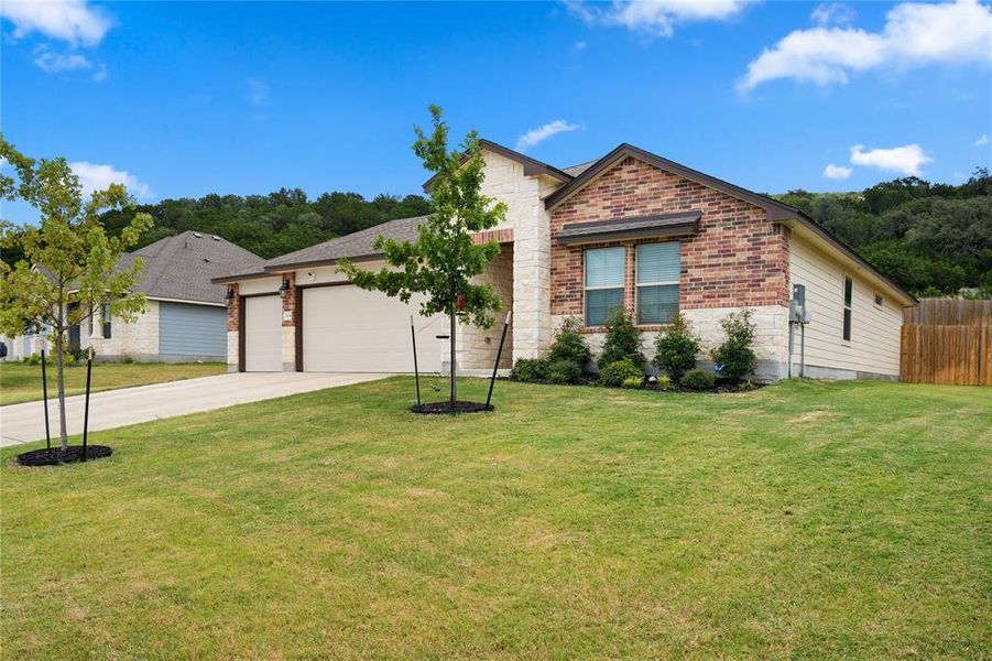Ranch-style house with brick siding, driveway, and a garage