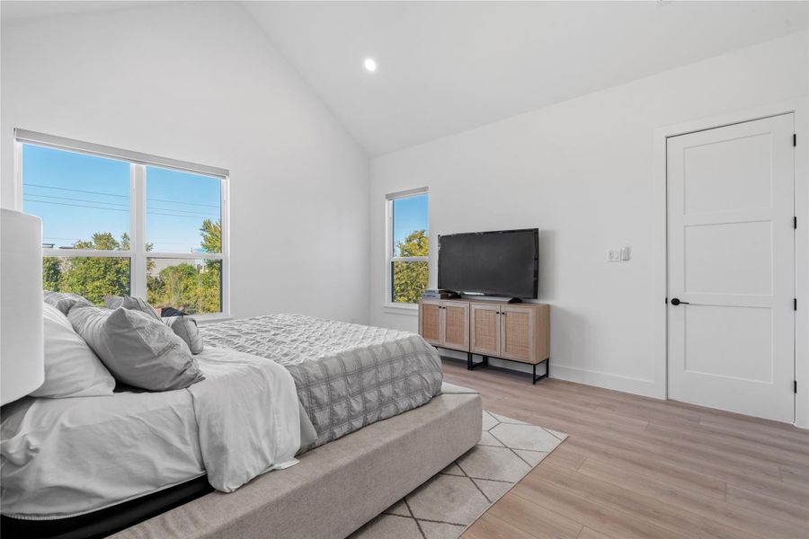 Angled ceiling lines and well-placed window openings give the bedroom a sense of volume and light, reinforcing a calm, airy atmosphere without visual clutter.