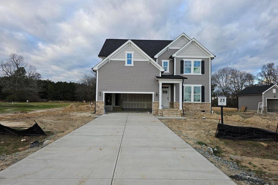 Front exterior of a new home in Wellers Knoll, Lillington, NC, highlighting curb appeal (Image 3). Front exterior of a new home in Wellers Knoll, Lillington, NC, highlighting curb appeal (Image 3).