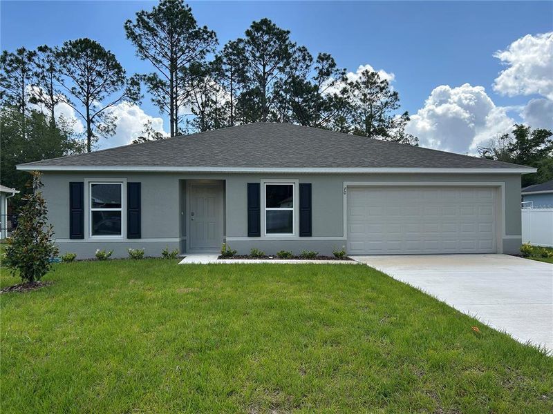 Front exterior of a new home in Palm Coast: Value Collection, Palm Coast, FL, highlighting curb appeal (Image 12).