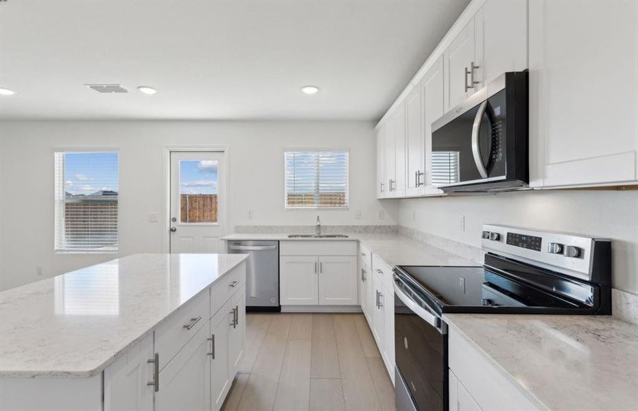 Spacious kitchen with oversized island *real home pictured