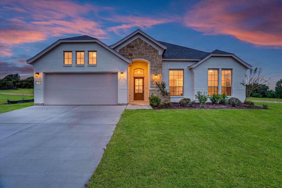 Contemporary single-story home featuring a white brick exterior with stone accents