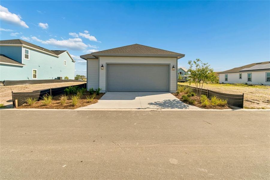 Front exterior of a new home in Weslyn Park in Sunbridge 34', St. Cloud, FL, highlighting curb appeal (Image 16).