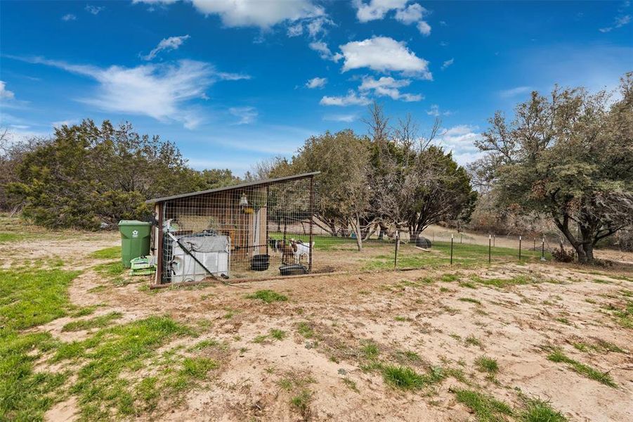 View of yard with a rural view and an outbuilding