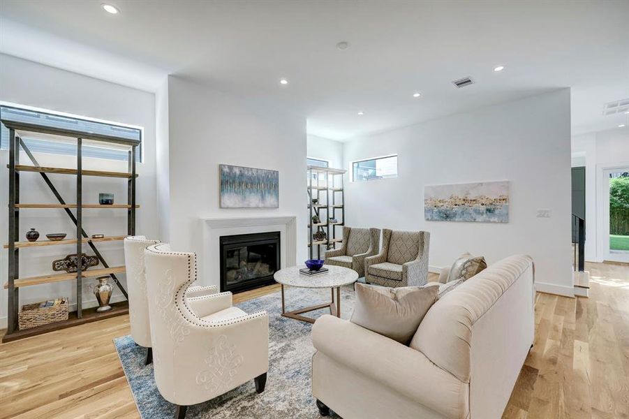 Great room with 11 ft. ceilings and fireplace highlighted by wine room