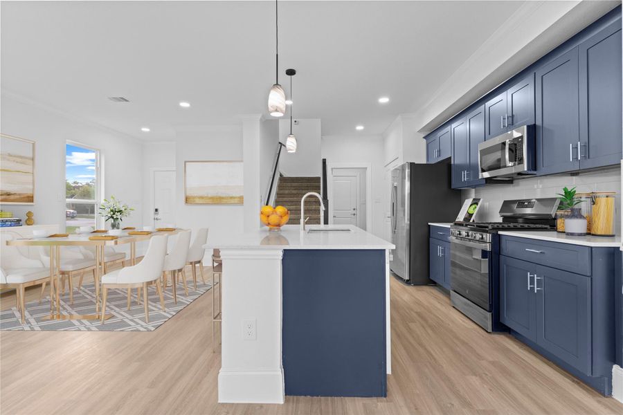 The beautiful eat in working station island has deep stainless-steel sink with swan pull out kitchen faucet and so much more custom features.