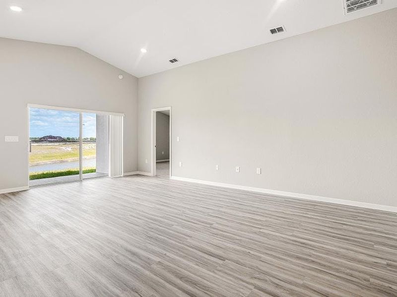 This home features a sunny, open living area with volume ceilings - Sophia by Highland Homes