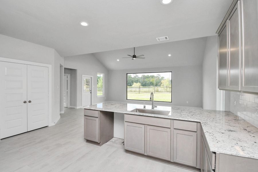 The open concept effortlessly connects the kitchen to the expansive family room, forming a perfect hub for gatherings. This seamless flow creates an inviting space where cooking and socializing come together harmoniously. Sample photo of completed home with similar floor plan. Actual colors and selections may vary.