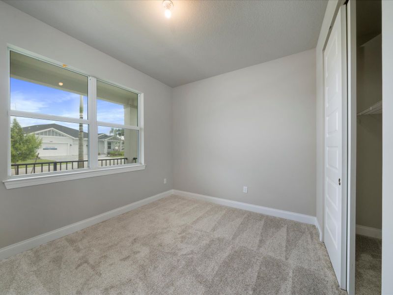 Bedroom in the Coral floorplan at 6295 NW Sweetwood Drive in Brystol at Wylder