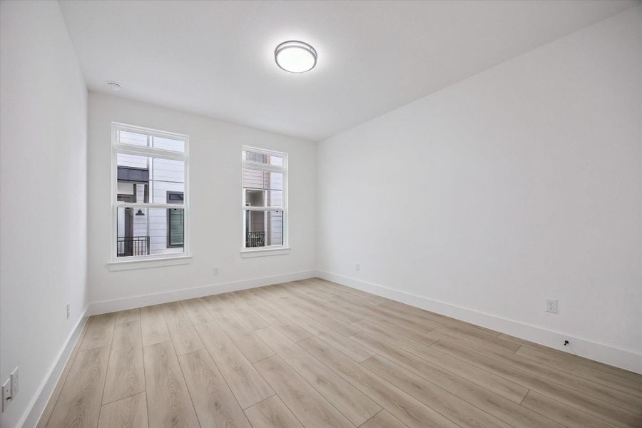 Bright secondary bedroom with clean lines and natural light Bright secondary bedroom with clean lines and natural light