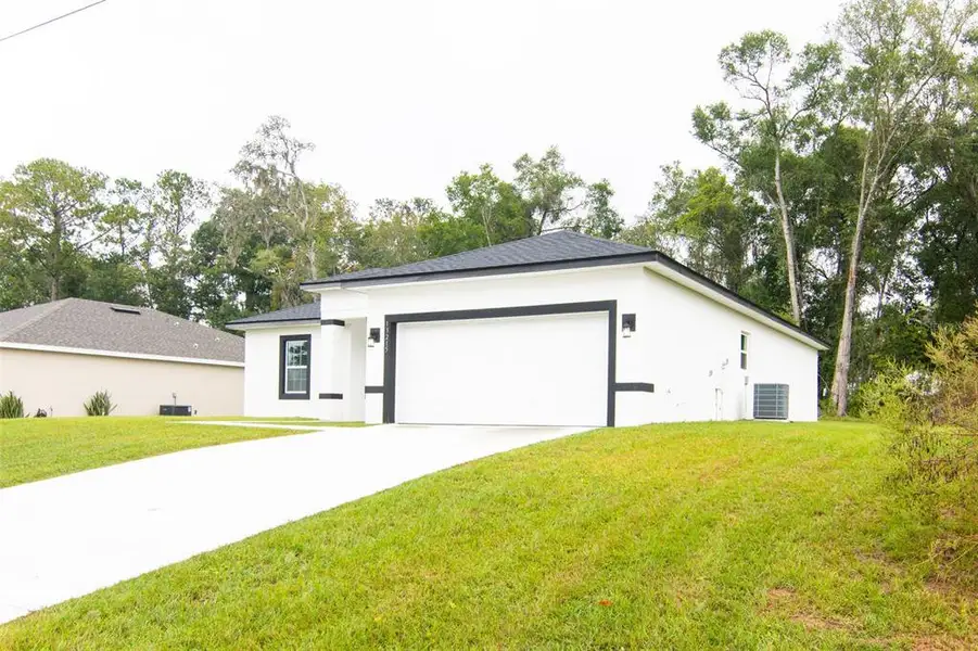 Front exterior of a new home in , Ocala, FL, highlighting curb appeal (Image 1).