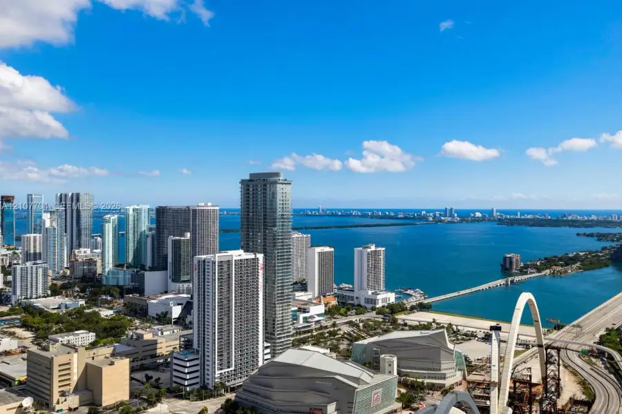 High-altitude urban perspective featuring expansive coastal scenery, waterfront exposure, and a dense cityscape skyline