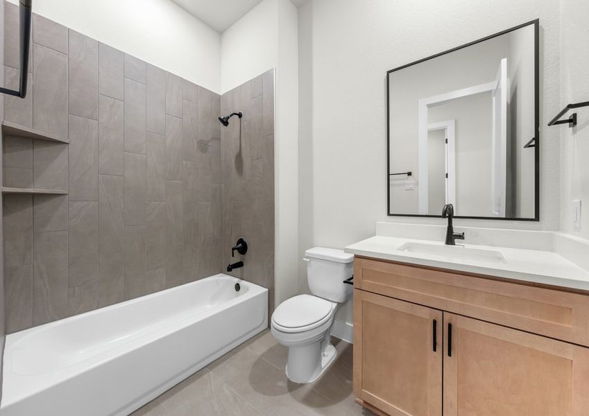 The secondary bathroom has a vanity and shower-tub combo.
