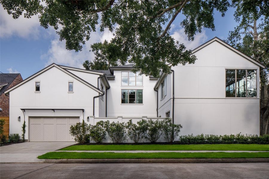 Fresh from the builder and beautifully buttoned up. A private drive leads to the attached garage while mature trees soften the home's crisp new construction and clean architectural lines.