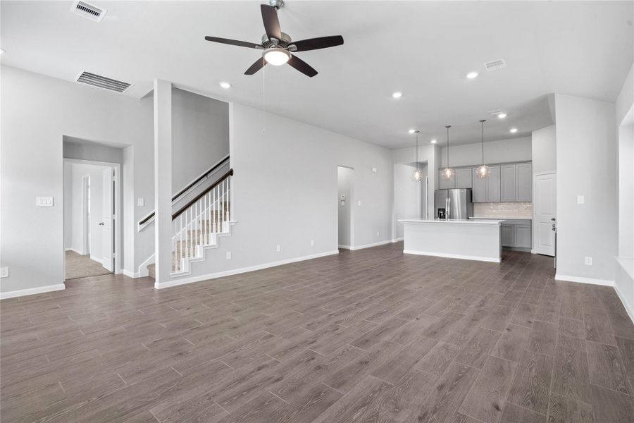 This expansive view from Great Room showcases a seamless, open-concept layout that creates a warm and inviting path for guests.